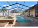Beautiful backyard pool area with a heated spa, screened enclosure, and ample lounge space at 8321 9Th Avenue Nw Ter, Bradenton, FL 34209
