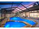 Enjoy the private screened-in pool with a spa, ideal for relaxing and entertaining outdoors with a beautiful twilight overhead at 8321 9Th Avenue Nw Ter, Bradenton, FL 34209