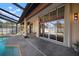 Backyard pool and spa with screened enclosure, complemented by a comfortable lounge area and a clear sky at 8321 9Th Avenue Nw Ter, Bradenton, FL 34209
