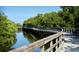 Wooden walkway above a canal surrounded by trees at 8321 9Th Avenue Nw Ter, Bradenton, FL 34209