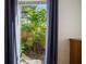 A close-up of the lush, landscaped yard and the exterior view through the bedroom window at 8321 9Th Avenue Nw Ter, Bradenton, FL 34209