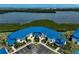 Waterfront condo complex with blue roof and lush landscaping overlooking bay at 939 Sandpiper Cir, Bradenton, FL 34209