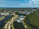 An aerial view showcasing a community's harmonious blend of residential areas, green spaces, and aquatic amenities at 939 Sandpiper Cir, Bradenton, FL 34209