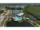 An aerial view of the community clubhouse with a pool, tennis courts, and a convenient parking area at 939 Sandpiper Cir, Bradenton, FL 34209