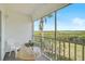 Relaxing screened balcony with seating offers beautiful water views and lush greenery at 939 Sandpiper Cir, Bradenton, FL 34209
