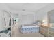 Comfortable bedroom featuring twin bed, dresser, closet, and ample natural light from the window at 939 Sandpiper Cir, Bradenton, FL 34209