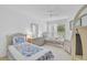 Comfortable bedroom featuring twin beds with blue floral bedding and ample natural light from the window at 939 Sandpiper Cir, Bradenton, FL 34209