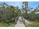 A wooden bridge leads through a scenic wooded area, offering a tranquil escape into nature's beauty at 939 Sandpiper Cir, Bradenton, FL 34209