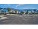 Inviting white condos feature blue metal roofs, lush landscaping and ample parking space for residents and guests at 939 Sandpiper Cir, Bradenton, FL 34209