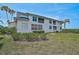 Two-story condo building showcases bright blue roofs and well-manicured landscaping at 939 Sandpiper Cir, Bradenton, FL 34209