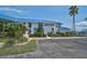 The exterior of a well-maintained condo featuring a blue roof and lush landscaping, offering a serene and inviting curb appeal at 939 Sandpiper Cir, Bradenton, FL 34209