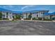Charming white condos feature blue metal roofs, manicured lawns, and easy access to parking at 939 Sandpiper Cir, Bradenton, FL 34209