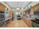 Kitchen with light wood cabinets, stainless steel appliances and tiled flooring at 939 Sandpiper Cir, Bradenton, FL 34209