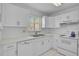 Bright kitchen featuring white cabinets and appliances, maximizing space at 939 Sandpiper Cir, Bradenton, FL 34209