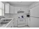 Kitchen with white cabinets and appliances, offering a clean aesthetic at 939 Sandpiper Cir, Bradenton, FL 34209