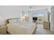 Bright main bedroom with a king bed, neutral decor, and a large window with outdoor views at 939 Sandpiper Cir, Bradenton, FL 34209