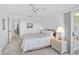 Bright main bedroom with a king bed, neutral decor, and access to outdoor patio at 939 Sandpiper Cir, Bradenton, FL 34209