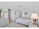 Bright main bedroom with a king bed, neutral decor, and entry to bathroom and hallway at 939 Sandpiper Cir, Bradenton, FL 34209