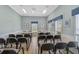 Bright community meeting room with ample seating, tables, and natural light from large windows at 939 Sandpiper Cir, Bradenton, FL 34209