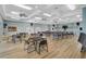 Large meeting room with tables, chairs, ceiling fans, and wood flooring at 939 Sandpiper Cir, Bradenton, FL 34209