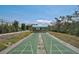 Outdoor shuffleboard court surrounded by lush greenery, for recreational play and exercise at 939 Sandpiper Cir, Bradenton, FL 34209