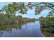 A peaceful waterway winding through lush greenery, providing a serene and picturesque natural view at 939 Sandpiper Cir, Bradenton, FL 34209