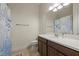 Well-lit bathroom with a combo shower/tub with a coastal patterned curtain and single sink vanity at 9769 Highland Park Pl, Palmetto, FL 34221