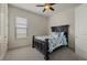 Comfortable bedroom with a ceiling fan, window, neutral carpeting and furniture at 9769 Highland Park Pl, Palmetto, FL 34221