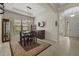 Elegant dining room with tray ceiling, designer lighting, and easy access to the entry at 9769 Highland Park Pl, Palmetto, FL 34221