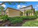 Well-manicured front yard showcasing a home with mature landscaping at 9769 Highland Park Pl, Palmetto, FL 34221