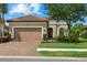 Charming single-story home with a well-maintained front yard and brick driveway at 9769 Highland Park Pl, Palmetto, FL 34221