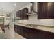 Bright kitchen with granite countertops, dark wood cabinets, and stainless steel range hood at 9769 Highland Park Pl, Palmetto, FL 34221