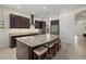 Modern kitchen with a large island, granite countertops, stainless steel appliances, and ample cabinet space at 9769 Highland Park Pl, Palmetto, FL 34221