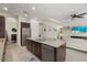 Kitchen island with granite countertop, stainless steel appliances, and tile flooring at 9769 Highland Park Pl, Palmetto, FL 34221