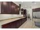 A kitchen featuring granite countertops, dark cabinetry, and stainless steel appliances at 9769 Highland Park Pl, Palmetto, FL 34221
