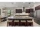 Modern kitchen with a large island, granite countertops, stainless steel appliances, and ample cabinet space at 9769 Highland Park Pl, Palmetto, FL 34221