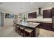 Modern kitchen with a large island, granite countertops, stainless steel appliances, and ample cabinet space at 9769 Highland Park Pl, Palmetto, FL 34221