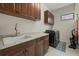 Functional laundry room with cabinets, granite countertops, utility sink, and front-load washer and dryer at 9769 Highland Park Pl, Palmetto, FL 34221