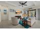 Living room with bright decor, light furniture, and sliding doors leading to the outdoors at 9769 Highland Park Pl, Palmetto, FL 34221