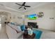 A bright living room with stylish decor, comfortable seating, and tile flooring at 9769 Highland Park Pl, Palmetto, FL 34221