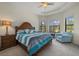 The main bedroom with large windows and a comfortable sitting area at 9769 Highland Park Pl, Palmetto, FL 34221