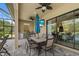Outdoor kitchen and dining area with a built-in grill and a view of the pool and landscaping at 9769 Highland Park Pl, Palmetto, FL 34221