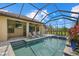 Inviting pool area with sun loungers, spa and screened-in patio, perfect for outdoor living at 9769 Highland Park Pl, Palmetto, FL 34221