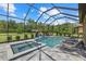 Relaxing screened pool and spa with lush green surroundings, and lounge chairs at 9769 Highland Park Pl, Palmetto, FL 34221