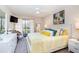 Inviting bedroom with a cozy bed, private balcony access, and bright decor at 104 Capri Isles Blvd # 207, Venice, FL 34292