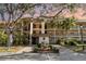 Inviting condo building featuring lush landscaping, mature trees, and convenient parking at 104 Capri Isles Blvd # 207, Venice, FL 34292
