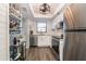 Beautiful kitchen with stainless steel appliances, white cabinets, and modern fixtures at 104 Capri Isles Blvd # 207, Venice, FL 34292