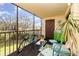 Cozy screened patio featuring charming furniture, providing a relaxing outdoor space to enjoy the scenery at 104 Capri Isles Blvd # 207, Venice, FL 34292
