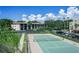 Well-maintained tennis court with ample parking and lush greenery in the background, perfect for active lifestyles at 104 Capri Isles Blvd # 207, Venice, FL 34292