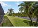 Beautiful landscaped backyard with a view of the lake and tropical palm trees at 10523 Old Grove Cir, Bradenton, FL 34212
